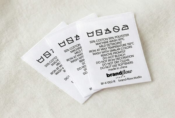 Printed soft cotton care label showing wash symbols, fibre content, size details and country of origin